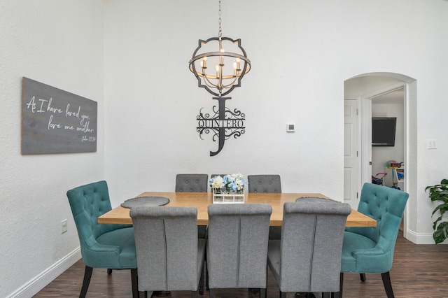 dining room with a notable chandelier and dark hardwood / wood-style floors