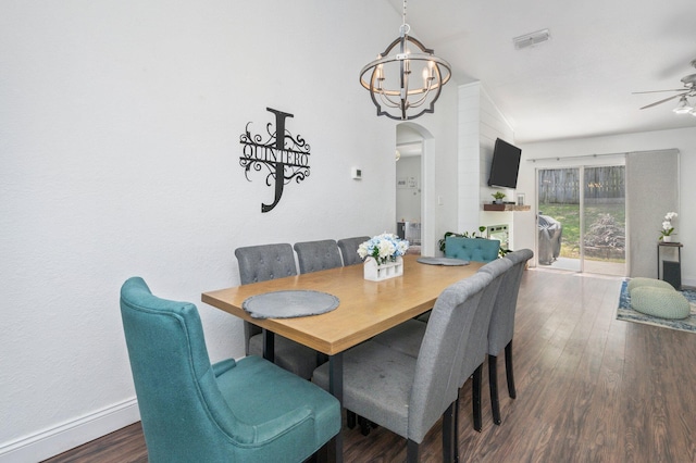 dining room with ceiling fan with notable chandelier and wood-type flooring