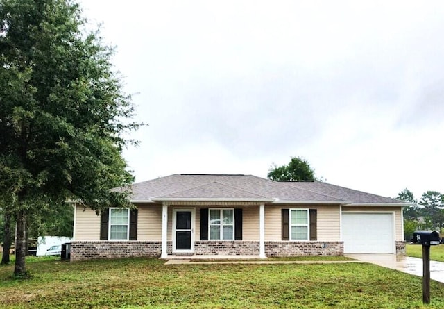single story home featuring brick siding, an attached garage, driveway, and a front lawn