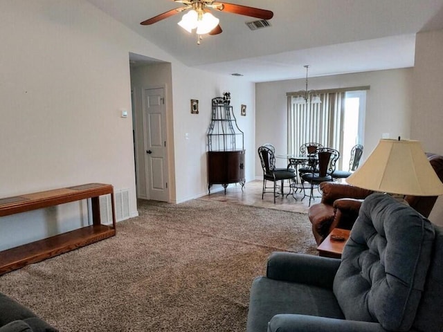 living area featuring a ceiling fan, a chandelier, vaulted ceiling, carpet floors, and baseboards
