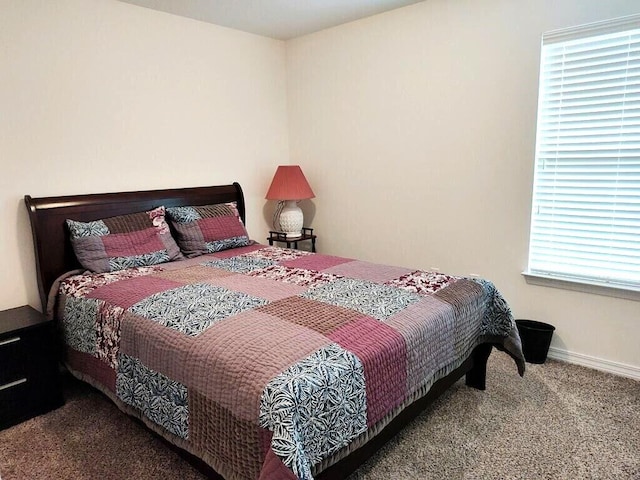 carpeted bedroom featuring baseboards