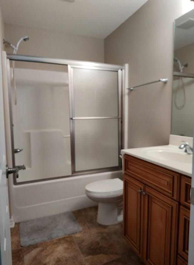 full bathroom with shower / bath combination with glass door, toilet, and vanity