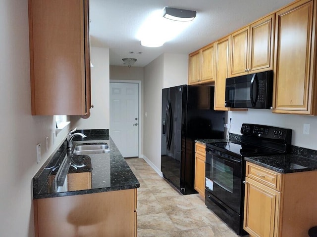 kitchen with black appliances, a sink, and dark stone counters