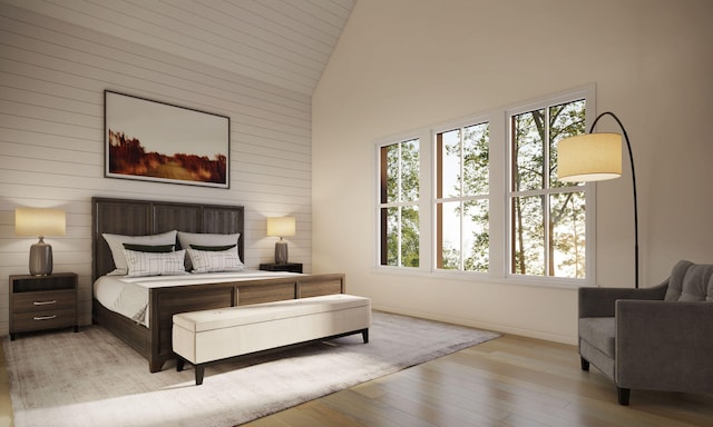 bedroom featuring light wood-type flooring and high vaulted ceiling