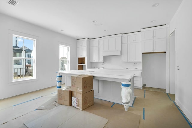 kitchen with white cabinetry and a center island