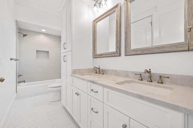 full bathroom featuring vanity, toilet, and tiled shower / bath combo