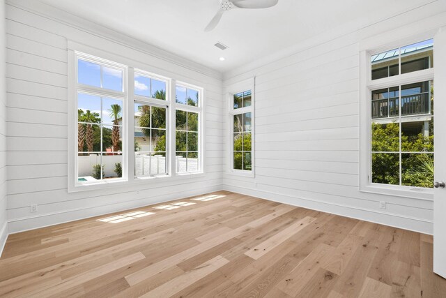 unfurnished sunroom with a healthy amount of sunlight and ceiling fan