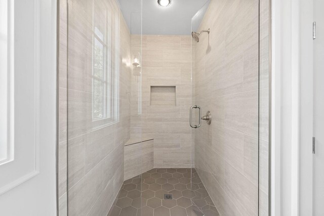 bathroom featuring a shower with shower door