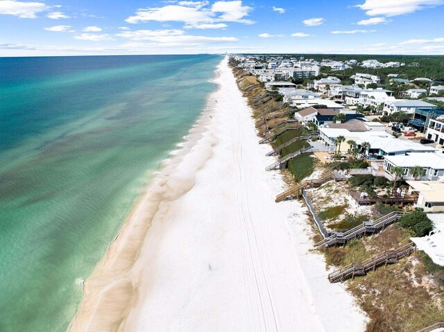 birds eye view of property featuring a beach view and a water view