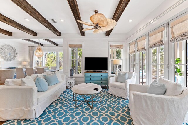 living room featuring ceiling fan, beamed ceiling, and french doors