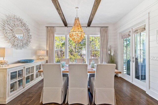 dining area with beam ceiling, french doors, dark hardwood / wood-style flooring, and a chandelier