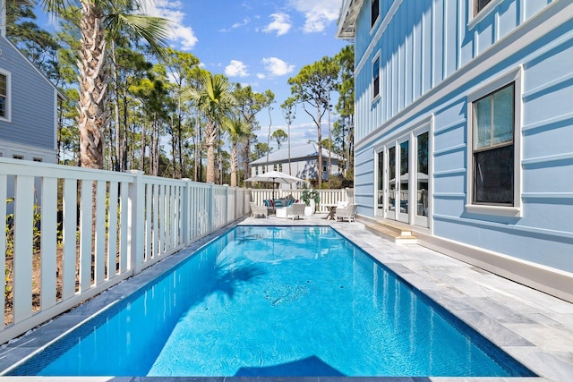 view of pool with a patio and french doors