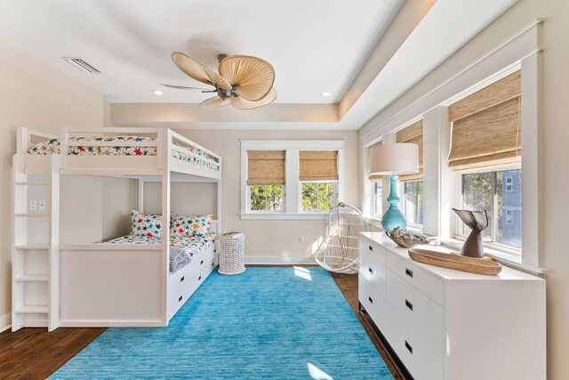 bedroom with ceiling fan and dark wood-type flooring