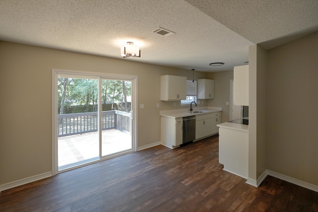 kitchen featuring sink, stainless steel dishwasher, a textured ceiling, and dark hardwood / wood-style flooring