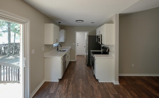 kitchen with sink, appliances with stainless steel finishes, and dark hardwood / wood-style flooring