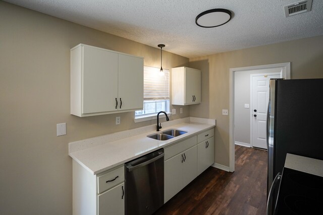 kitchen featuring dark wood-type flooring, sink, decorative light fixtures, a textured ceiling, and stainless steel appliances