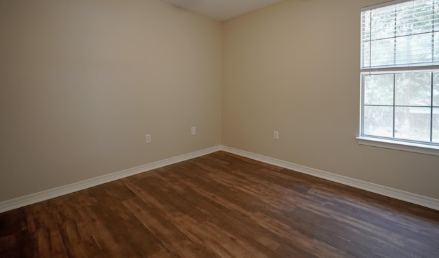 spare room with dark hardwood / wood-style flooring