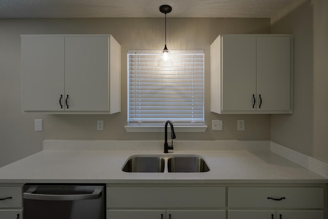 kitchen featuring sink, white cabinets, stainless steel dishwasher, and light stone counters