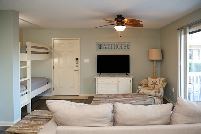 living room featuring hardwood / wood-style flooring and ceiling fan