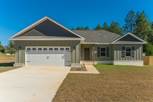 view of front of property featuring a front yard and a garage