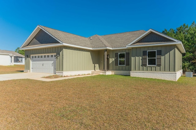 ranch-style home featuring cooling unit, a garage, and a front yard