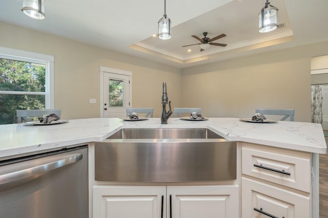 kitchen featuring dishwasher, white cabinetry, sink, and a tray ceiling