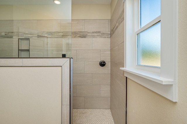 bathroom with a tile shower