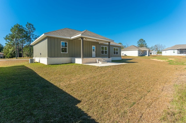 back of house featuring central air condition unit, a yard, and a patio