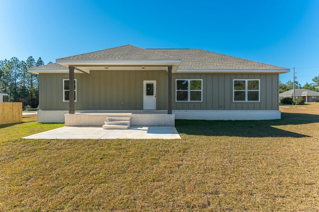 back of property featuring a patio area and a yard