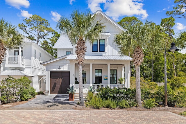 modern farmhouse style home featuring a garage and a porch