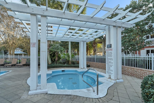 view of swimming pool featuring a hot tub, a pergola, and a patio