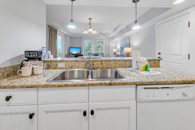 kitchen featuring a sink, white cabinetry, light stone countertops, dishwasher, and pendant lighting