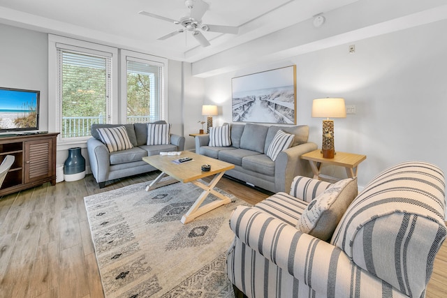 living area featuring ceiling fan and wood finished floors