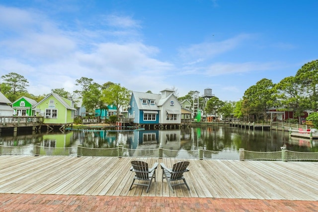 dock area with a water view and a fire pit