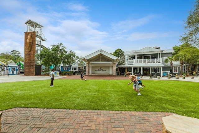 view of property's community with a lawn