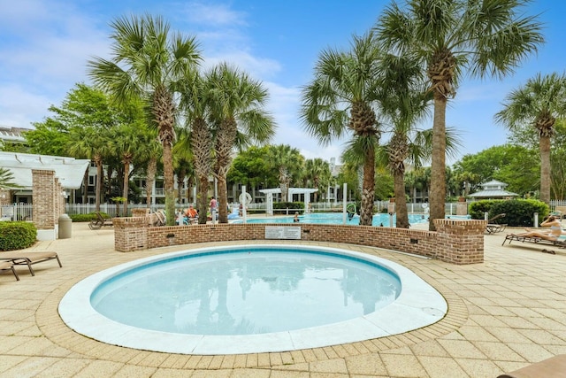 view of swimming pool with a patio, fence, and a pergola