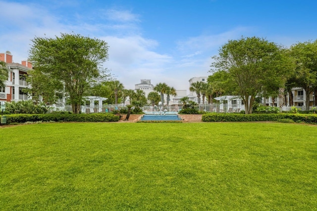 view of home's community with a yard