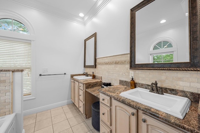 bathroom featuring backsplash, tile patterned flooring, crown molding, a bathing tub, and vanity