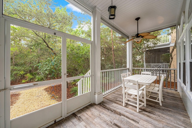 sunroom featuring wood ceiling, ceiling fan, and vaulted ceiling