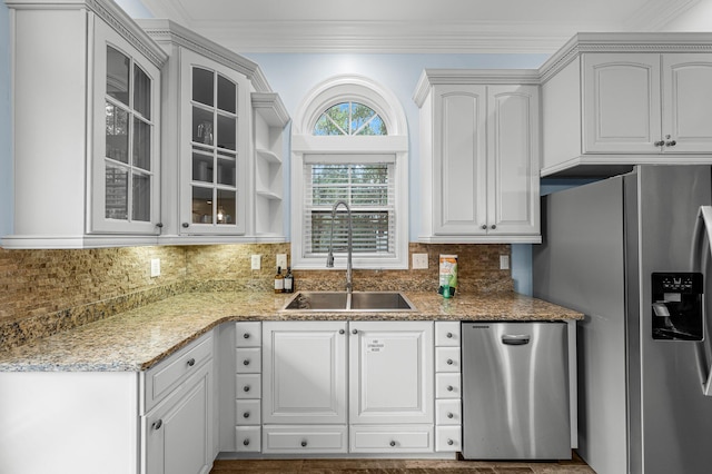 kitchen featuring crown molding, light stone counters, sink, appliances with stainless steel finishes, and white cabinets