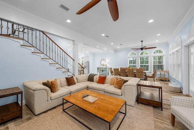 living room with ceiling fan and crown molding