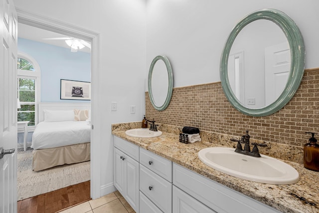 bathroom featuring vanity, hardwood / wood-style floors, and decorative backsplash