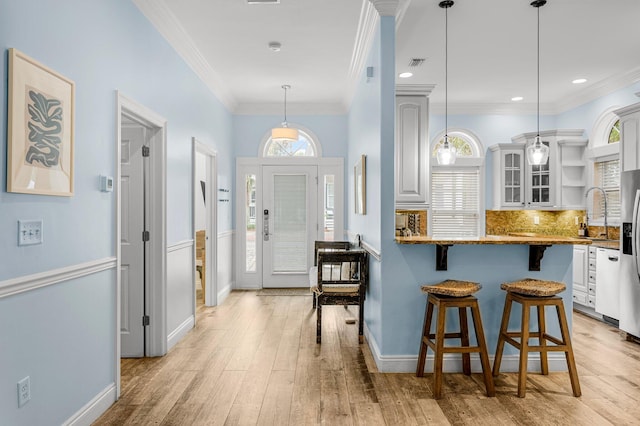 kitchen featuring white cabinetry, plenty of natural light, and light hardwood / wood-style floors