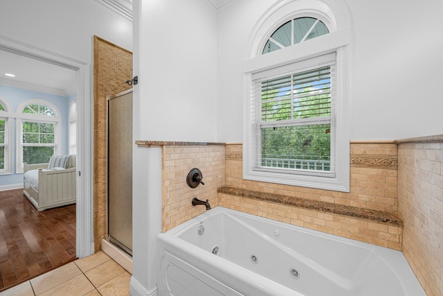 bathroom featuring ornamental molding, hardwood / wood-style flooring, and independent shower and bath