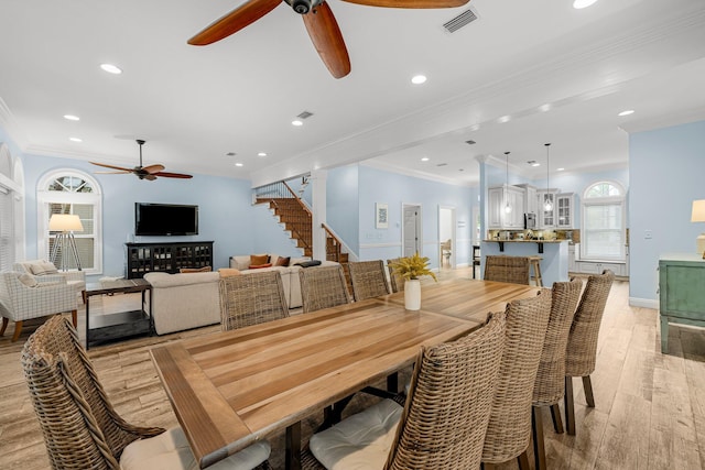 dining room featuring ornamental molding, ceiling fan, and light hardwood / wood-style floors