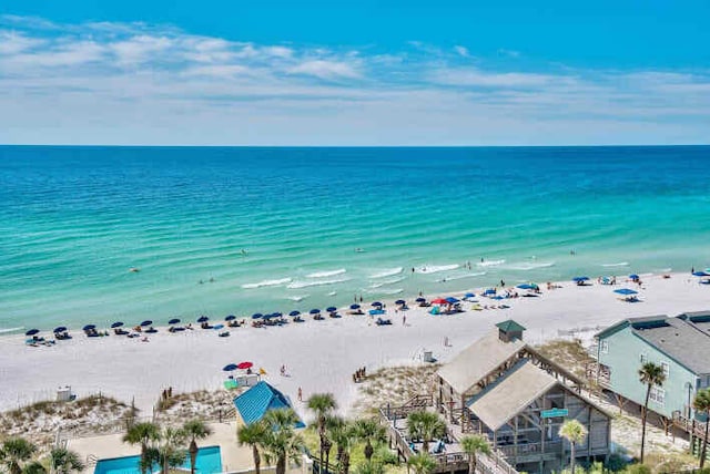 birds eye view of property featuring a beach view and a water view