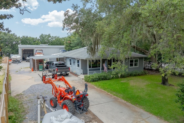 back of house with a garage and a lawn