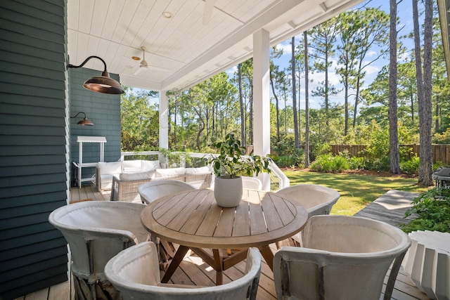 exterior space with ceiling fan and an outdoor living space