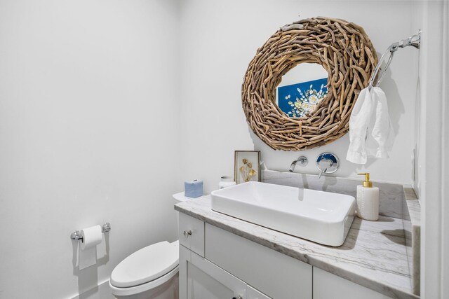 bathroom featuring toilet and vanity