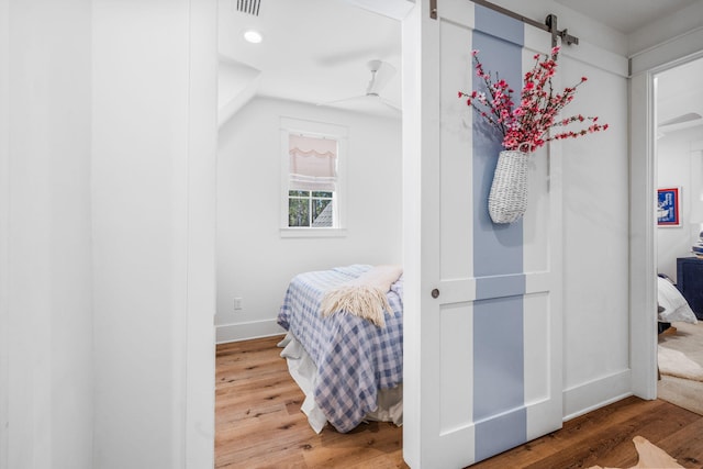 bedroom featuring vaulted ceiling and wood-type flooring